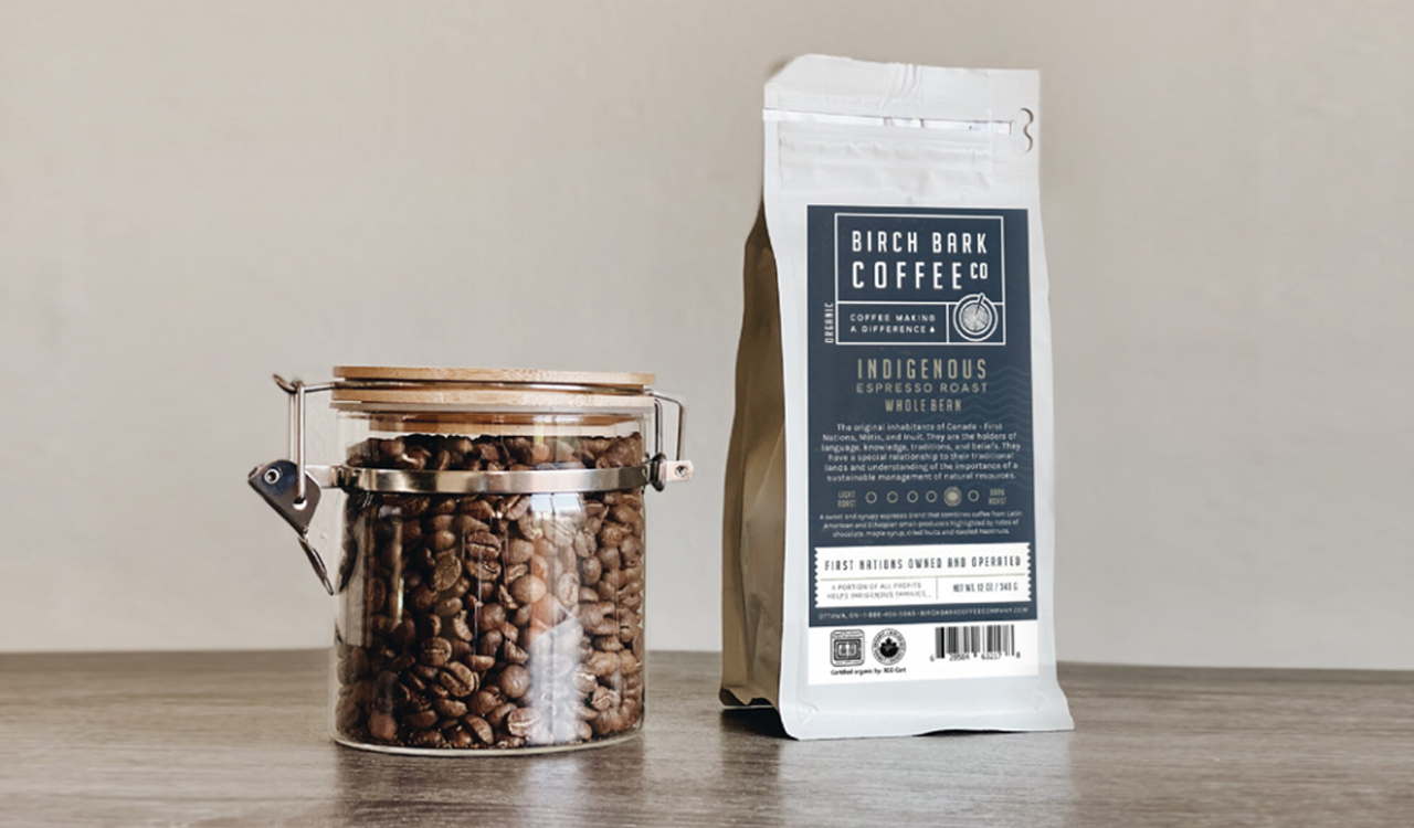 Birch Bark Coffee Company product in retail packaging and a glass jar with roasted coffee beans.