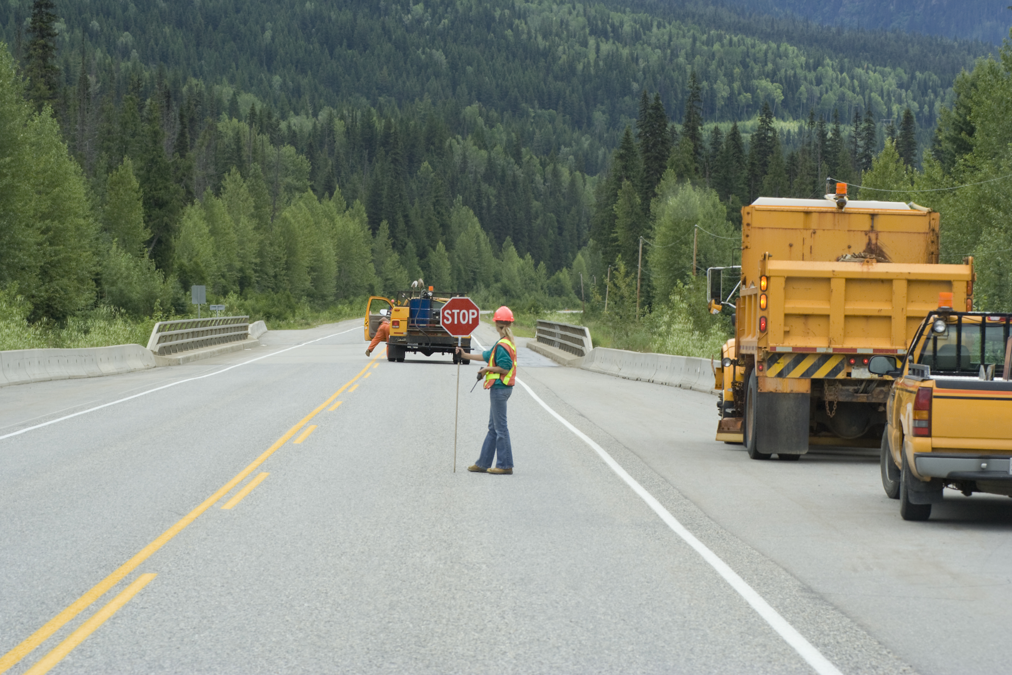 Construction workers on highway in Alberta completing roadwork