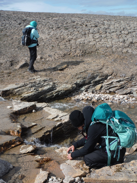 Two people at Tunnunik impact structure
